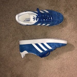 Blue and white Adidas Gazelles